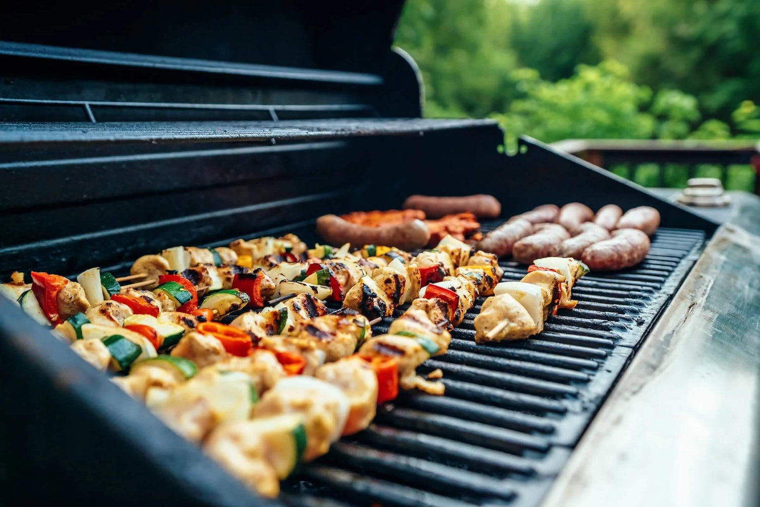 How to host an easy BBQ party. Image shows simple delicous chicken kebabs sizzling on a grill.