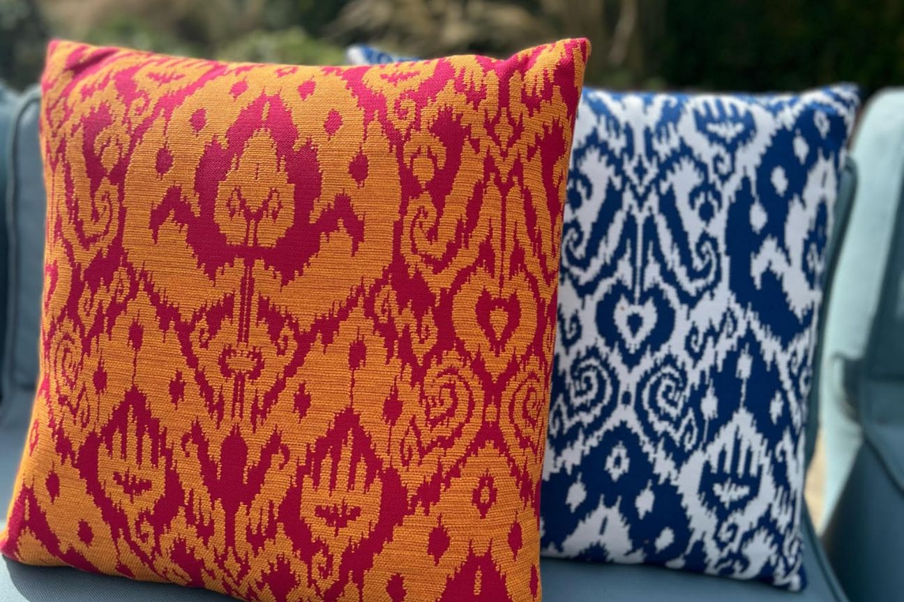 Colourful garden cushions in bright blue and azure blue.