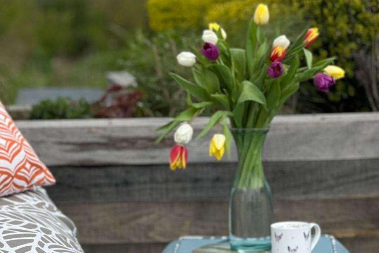 A gift of flowers on an outdoor table in the garden.