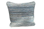 A fabric outdoor cushion on white background. The cushion is coloured in soft blues and greys, reminiscent of seafoam, in an unstructured pattern.