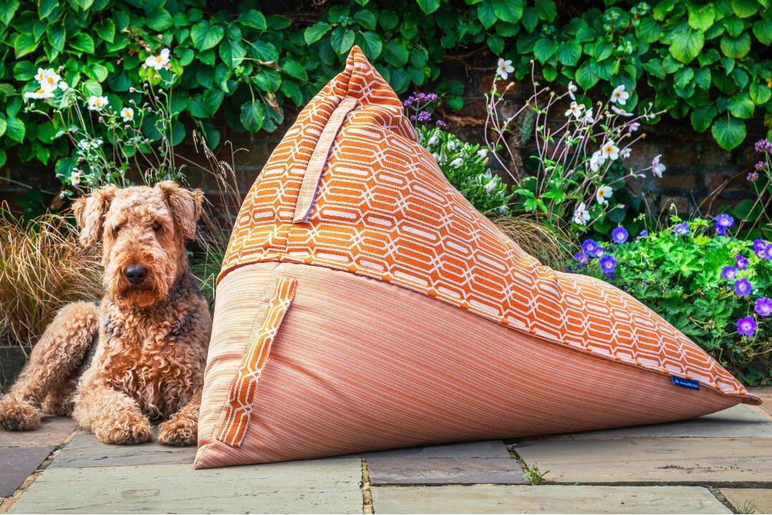 Orange and white patterned bean bag lounger in the garden.