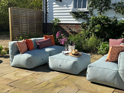 garden bean bag dining sofa set consisting of 4 chairs and 1 ottoman in ocean spray. decorated with orange cushions in calypso, woven tropic and medina tropic. 100% British made, water-resistant, stain-proof with 5 year guarantee