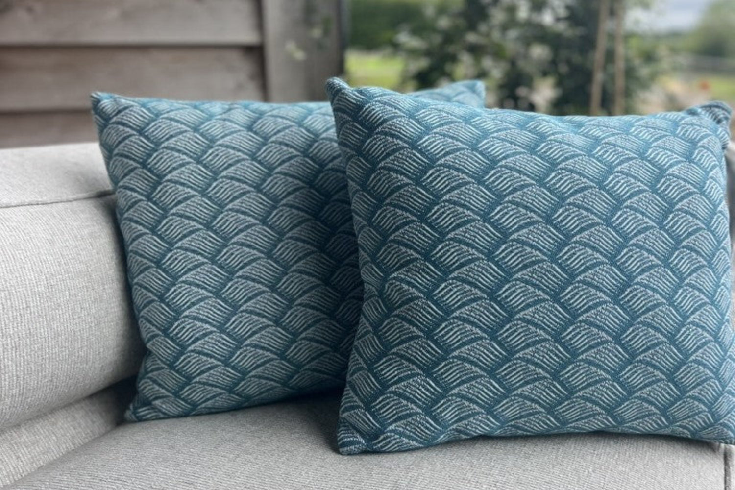 Two luxury outdoor cushions in our breeze pattern that comes in a blue teal colour on our shell sofa set.