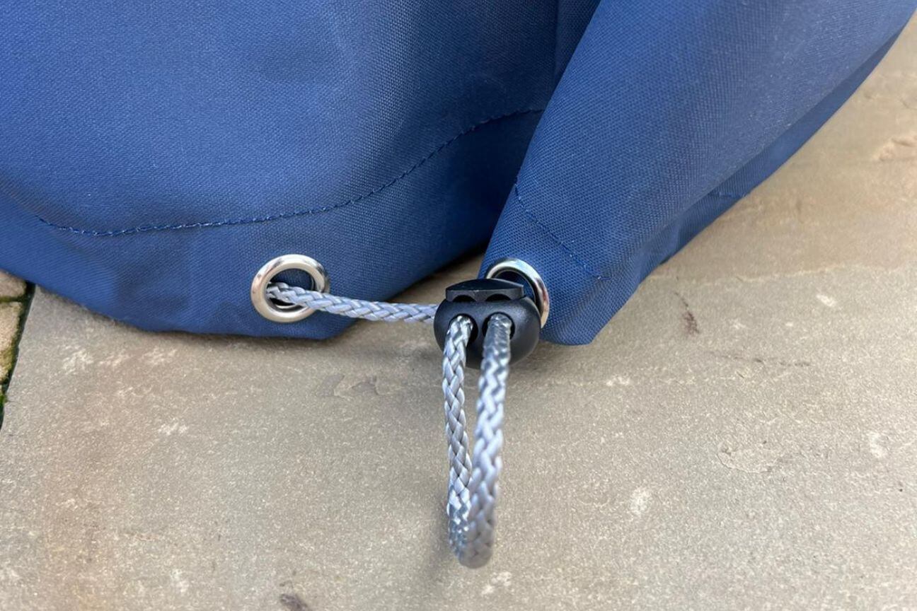 Toggle on the corner of a blue waterproof outdoor furniture cover