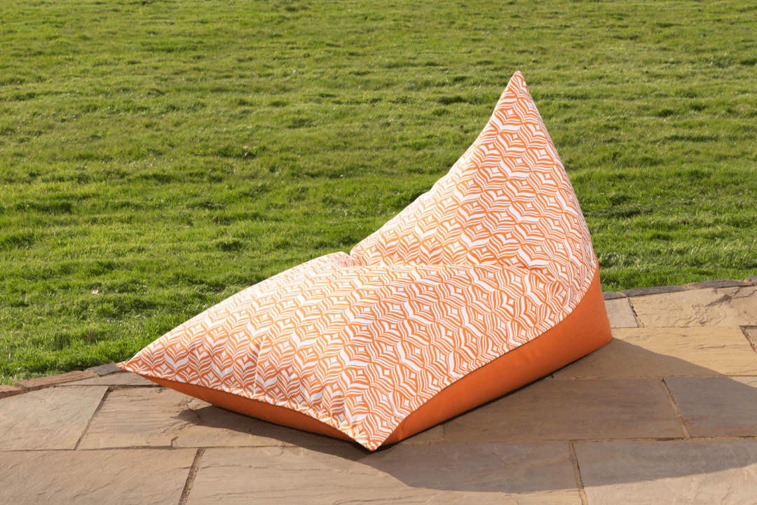 Outdoor bean bag lounger in orange providing a comfortable stylish seat in the sunshine