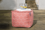 Garden pouffe as an outdoor table holding a refreshing jug of water and lemon