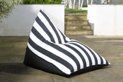 Black and white striped bean bag chair adding a comfortable monochrome seating for a garden patio
