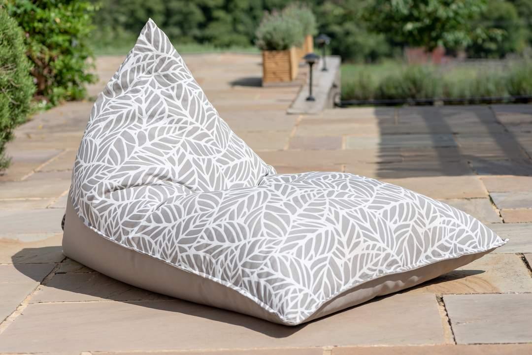 Grey and white patterned bean bag llounger outdoors on garden patio.